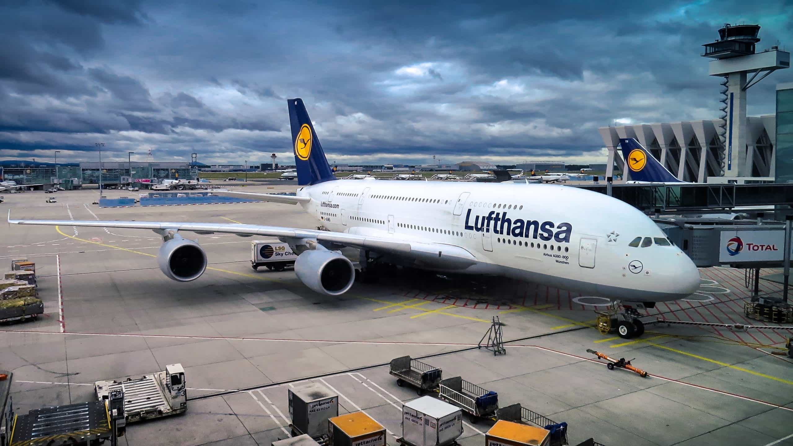 Lufthansa flight parked at gate.