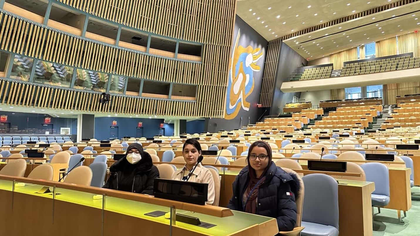 Three participating interns sitting in the General Assembly hall.