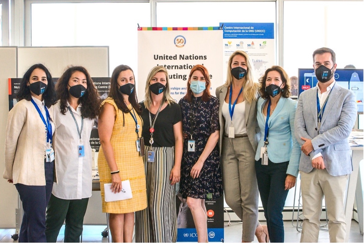 UNICC staff standing in front of UNICC banner during UN SG's visit to the UN Base in Valencia